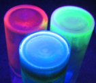 Luminescent ionic liquids based on manganese (green), cerium (blue), and europium (red) (Photo: Copyright Martyn J. Earle)